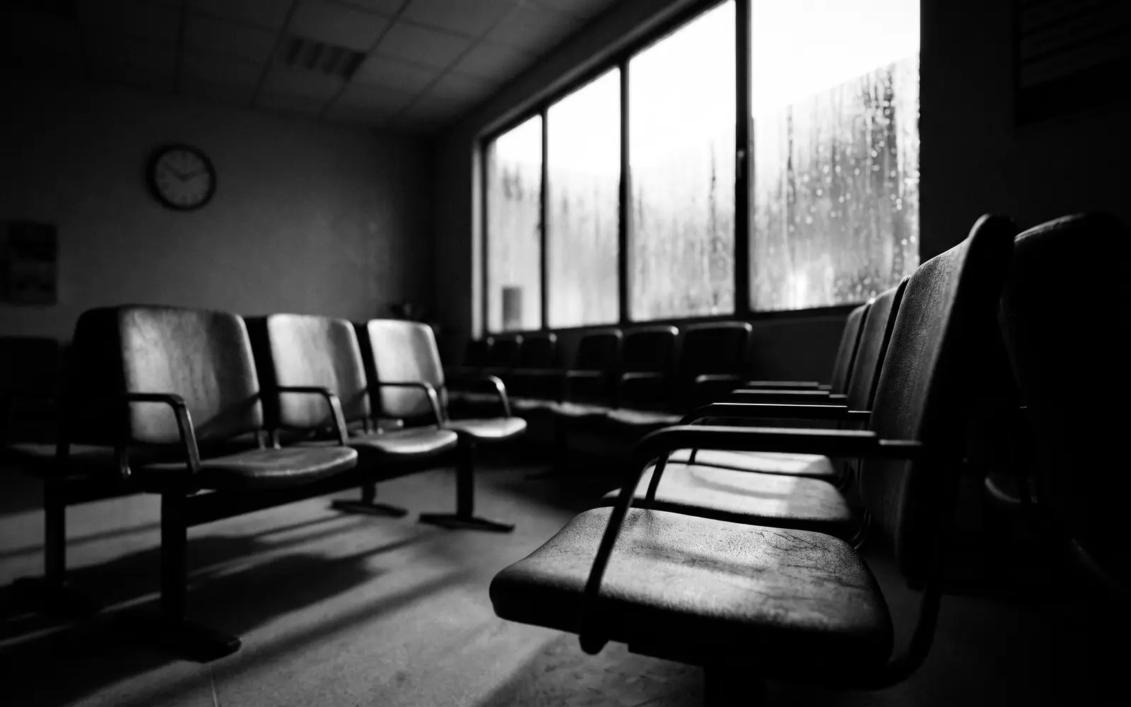 Empty hospital waiting room with rows of chairs
