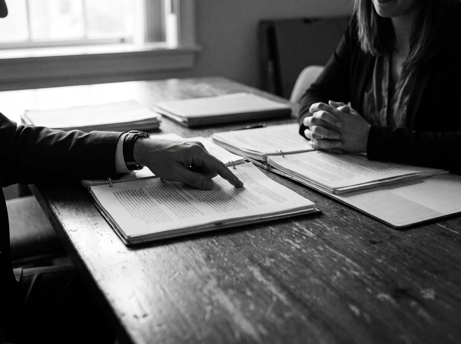 Attorney and client reviewing documents